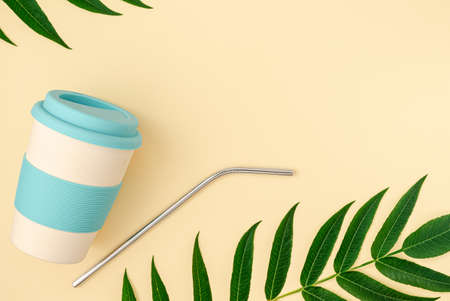 Bring your own cup concept. Bamboo eco cup and metal drinking straw on beige background. Copy space, top viewの写真素材