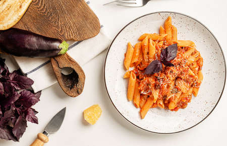 Italian pasta penne alla Norma with eggplant, tomato sause and parmesan cheese. Top view, overheadの写真素材