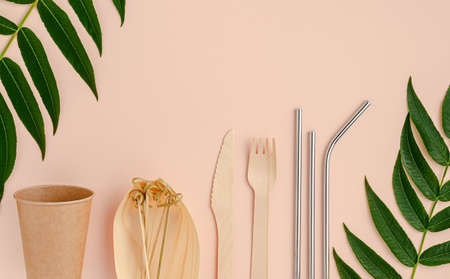 Eco cutlery and metal drinking straws on pink background. Zero waste concept.の写真素材