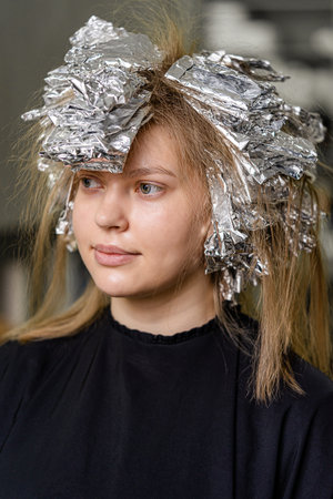 Foil on models hair. Trendy hair lightening using shatush technique.の写真素材
