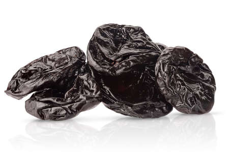 Heap of dried plums isolated on white background.の写真素材