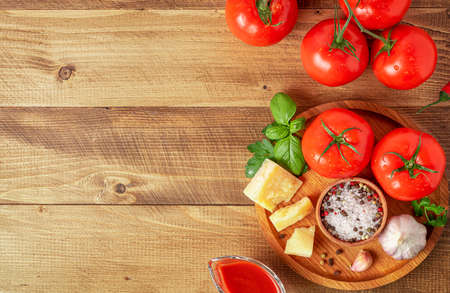 Tomatoes with ingredients for cooking. Italian cuisine concept. Top view, copy space.の写真素材