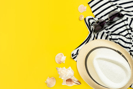 Summer lifestyle on bright yellow background. Top view, copy space.