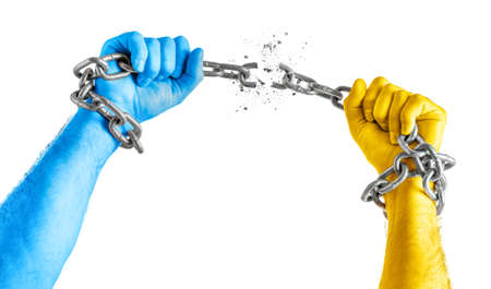 Mens hands in Ukraine flag colors break the chains. Isolated on white background. copy spaceの写真素材
