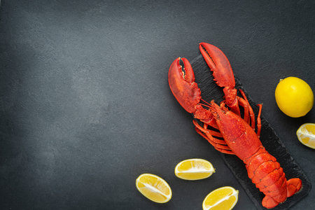 Red lobster with lemon on dark background. Directly above, copy space.