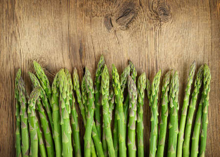 Row of green asparagus on wooden background. copyspace. high quality photoの写真素材