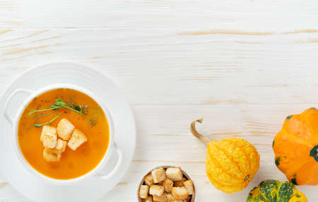 Pumpkin soup with croutons on white backgroundの写真素材
