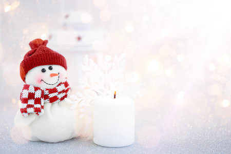 Snowy Christmas background with snowman, decorations and ornaments. Copy spaceの写真素材