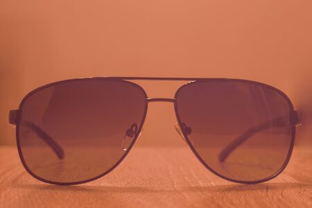 Sunglasses on a wooden background with vintage effect. Blurred backgroundの写真素材