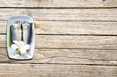 Short-bodied mackerel on Wood plank brown texture backgroundの写真素材