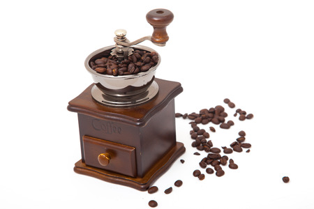 Isolated coffee bean grinder and fresh roasted coffee beanの写真素材