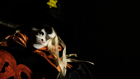 Scary skull monster wearing dark suit in the darkの写真素材