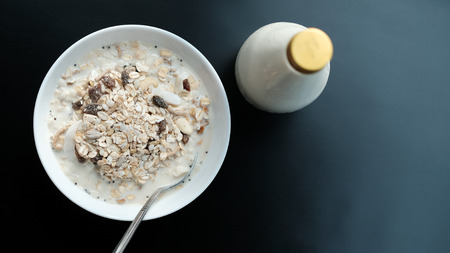 Morning granola breakfast with raisins and almond served with premium almond milkの写真素材