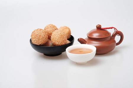 Isolated macro shot tea pot and tea cup and snack on white backgroundの写真素材