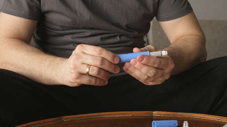 obese fat man preparing Semaglutide Ozempic injection control blood sugar levelsの写真素材