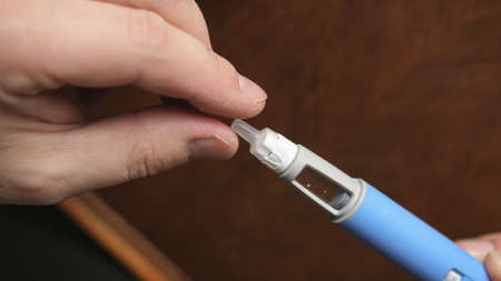 obese fat man preparing Semaglutide Ozempic injection control blood sugar levelsの写真素材