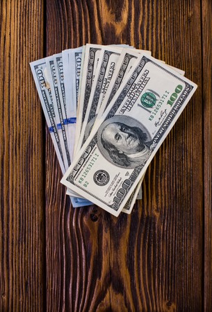 One Hundred Dollar Bill On The Wood Backgroundの写真素材