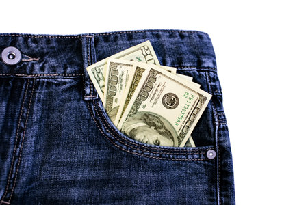 Dollar notes in a pocket of blue jeans