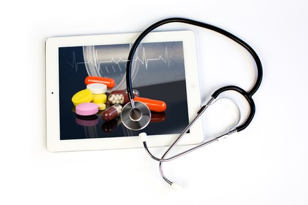 medicine stethoscope and tablet on a white backgroundの写真素材