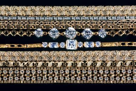 many gold chain necklaces over black backgroundの写真素材