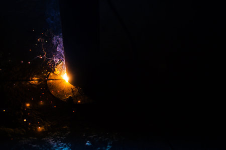 process of welding the metal with an electrode on the black background, banner with place for text