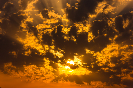 Sunset, the sun shines through the cloudsの写真素材