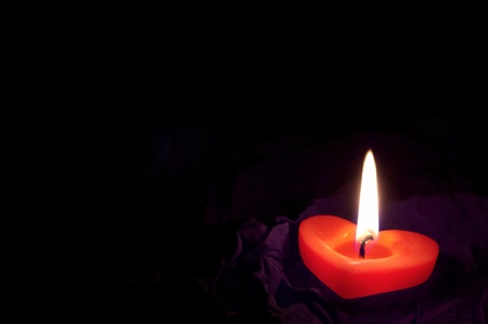  Coloured candle shaped heart on black backclothの写真素材
