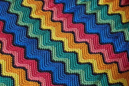 Detail of colorful knitted blankets pillows