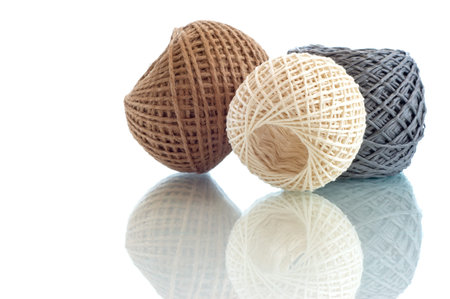 Three  balls of twine on a white background