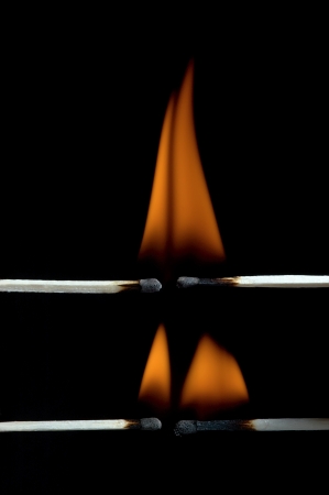 Burning matchstick on black backgroundの写真素材