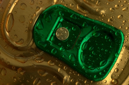 macro unopened cans of beer with drops of waterの写真素材