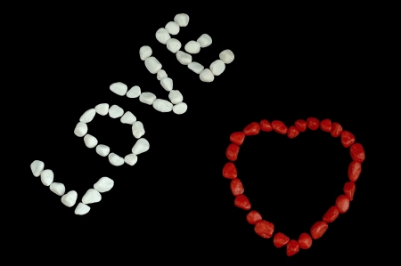 inscription and red love hearts of stones on a black backgroundの写真素材