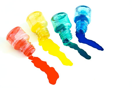 Spilled a bottle of blue, red,green and yellow  ink on white backgroundの写真素材