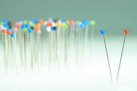different colored pins standing with backgroundの写真素材