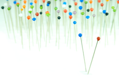 different colored pins on a white background