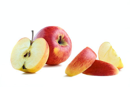 sliced apple pieces on white background