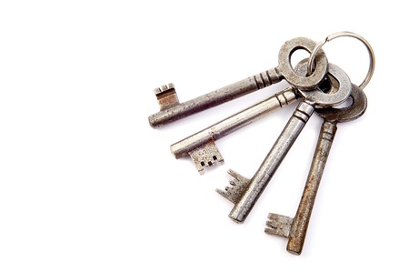 Bunch of old keys on a white backgroundの写真素材