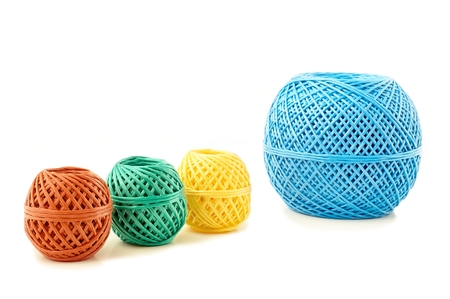 Different colored skeins twine on a white の写真素材