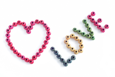 Red heart and an inscription love on a white backgroundの写真素材