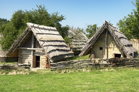 Two ancient dwelling with blue sky in the backgroundの写真素材