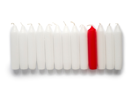 One red candle with white candle on white の写真素材