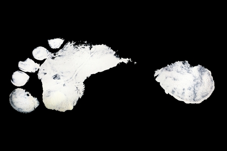 Detail print of the white foot on black backgroundの写真素材