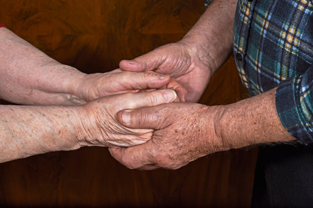 The old couple holding hands