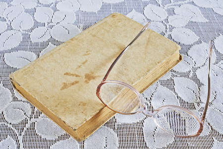 View of old books and glasses on the tableの写真素材