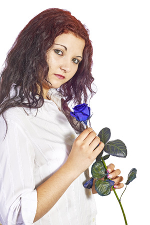 View of a young girl with blue roses on a white backgroundの写真素材