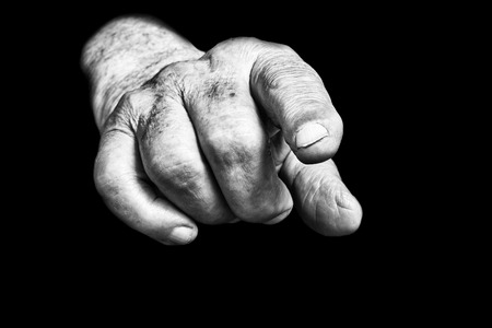 Senior hands on a black backgroundの写真素材