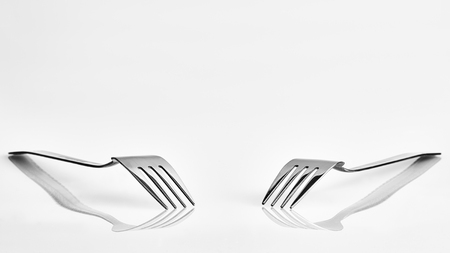 View of two forks with reflection and a clean backgroundの写真素材