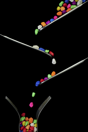 Small colored stones on a black backgroundの写真素材