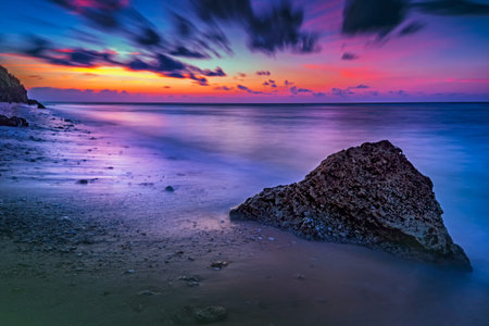 Morning view of the beach with stone and mysterious atmosphere