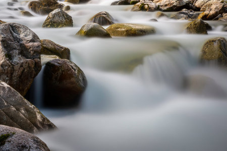 Group large stones in a mountain stream flowing